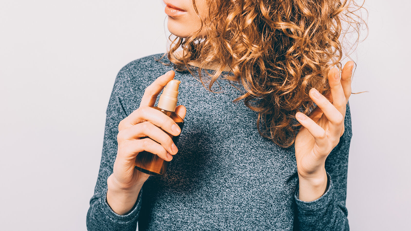 young-woman-holding-bottle-with-nutritional-oil