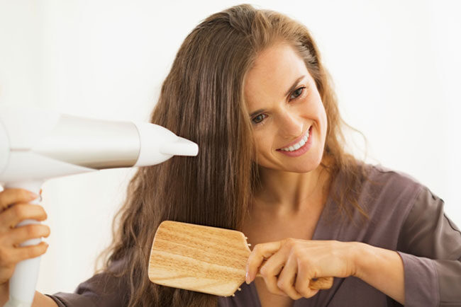 hair being blwon by hairdryer with red head